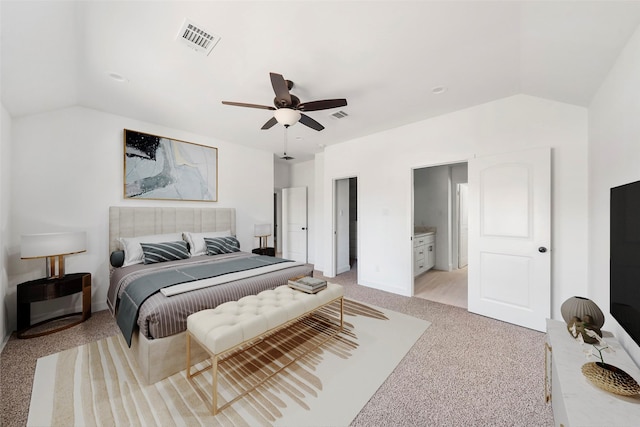 bedroom featuring ceiling fan, light colored carpet, lofted ceiling, and ensuite bathroom