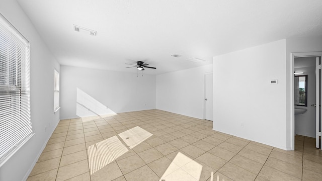 tiled empty room with ceiling fan