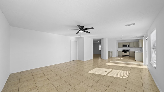 unfurnished living room featuring ceiling fan and light tile patterned floors