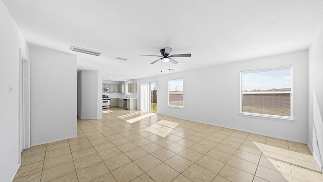 unfurnished living room featuring ceiling fan and light tile patterned floors