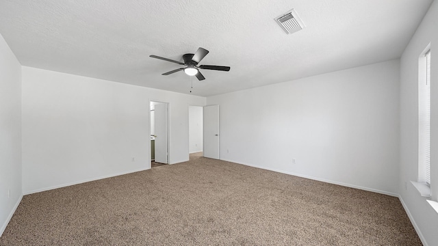 spare room featuring ceiling fan and carpet