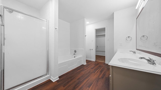 bathroom with wood-type flooring, vanity, and separate shower and tub