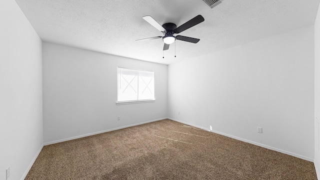 empty room featuring ceiling fan, carpet floors, and a textured ceiling