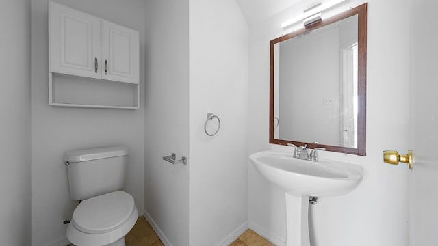 bathroom with tile patterned flooring and toilet