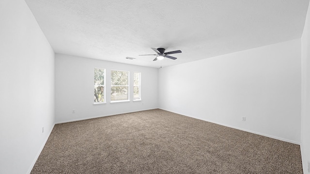 carpeted spare room featuring a textured ceiling and ceiling fan