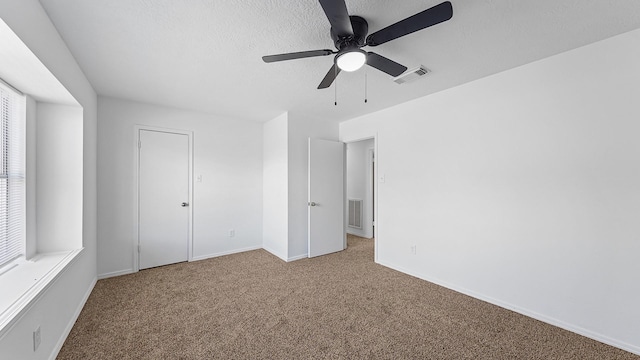 unfurnished bedroom with carpet floors, a closet, and ceiling fan