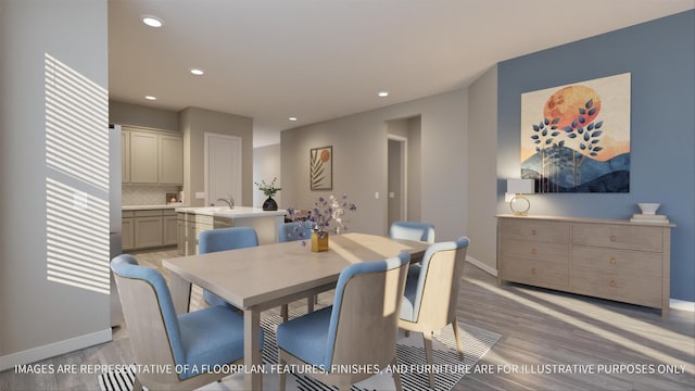 dining space featuring sink and light hardwood / wood-style flooring