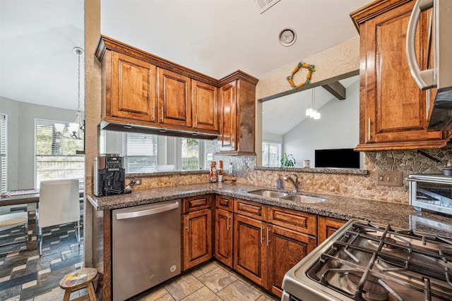 kitchen with stainless steel appliances, tasteful backsplash, lofted ceiling, and sink