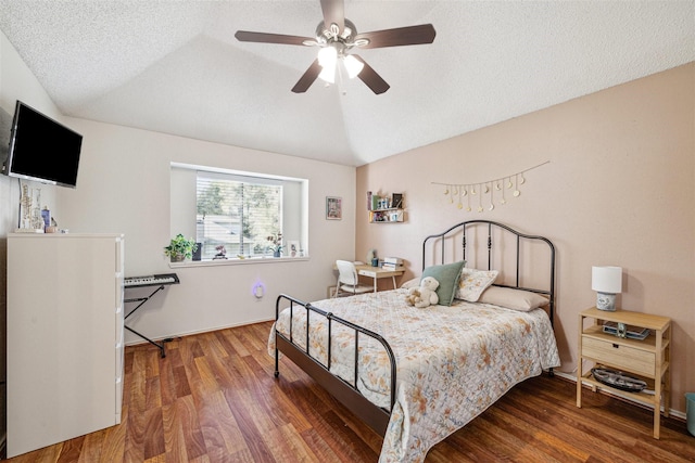 bedroom with a textured ceiling, ceiling fan, dark hardwood / wood-style floors, and lofted ceiling