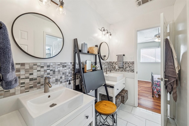 bathroom featuring decorative backsplash, vanity, tile patterned floors, and ceiling fan