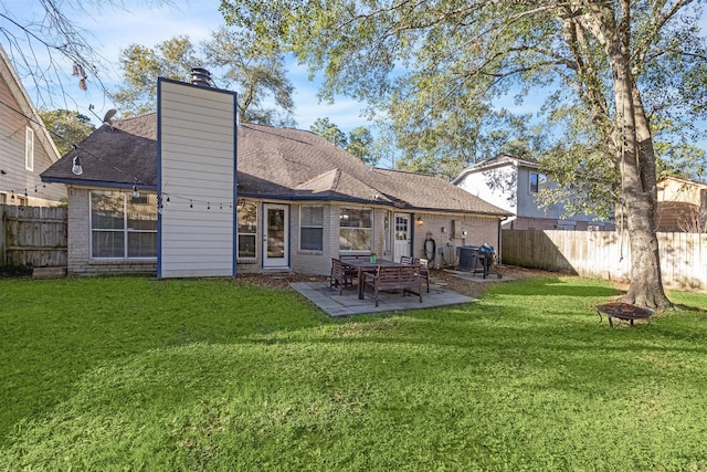 rear view of property with a yard and a patio