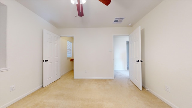 unfurnished bedroom featuring ceiling fan and light colored carpet