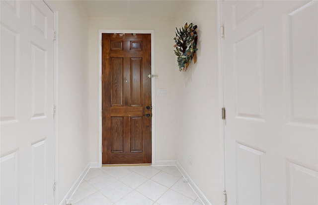 doorway with light tile patterned floors