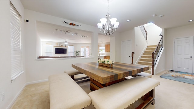 dining room with ceiling fan with notable chandelier