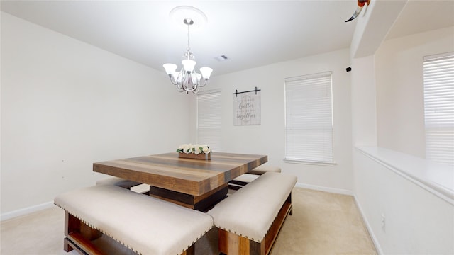 dining area featuring light colored carpet and a notable chandelier