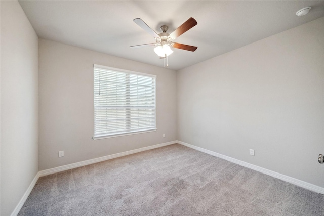 carpeted spare room with ceiling fan