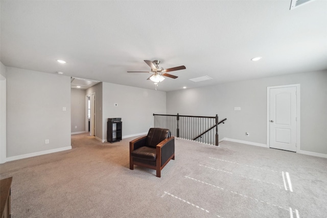 sitting room with light colored carpet and ceiling fan