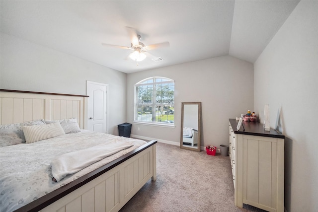 bedroom with ceiling fan, light colored carpet, and vaulted ceiling