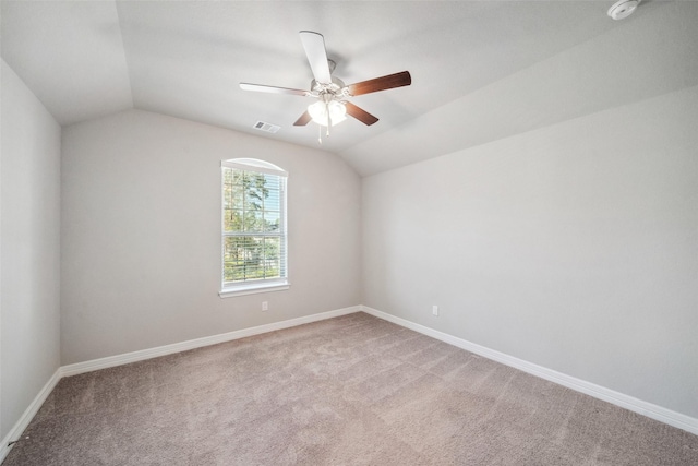 carpeted empty room with ceiling fan and lofted ceiling