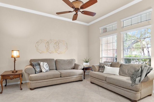 tiled living room with ceiling fan and crown molding