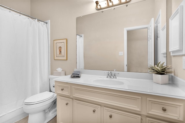 bathroom with tile patterned flooring, vanity, and toilet