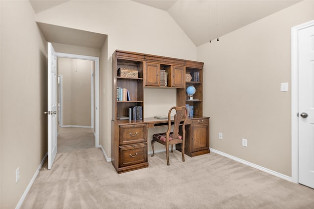 office space with lofted ceiling and light carpet