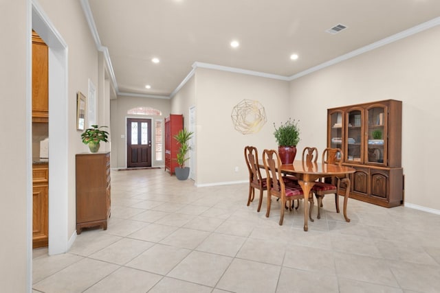 tiled dining space featuring crown molding