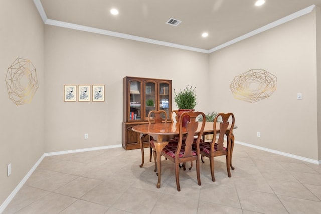 dining space with ornamental molding and light tile patterned floors