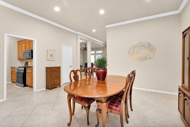 tiled dining area featuring ceiling fan and ornamental molding