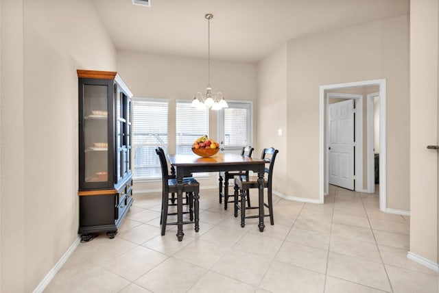 dining room with light tile patterned flooring and a notable chandelier