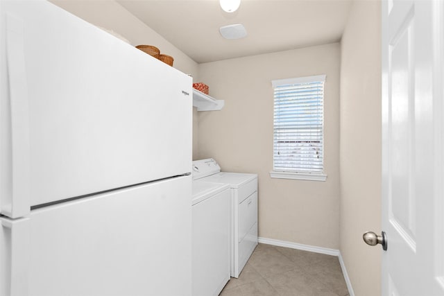 clothes washing area with washing machine and clothes dryer and light tile patterned floors