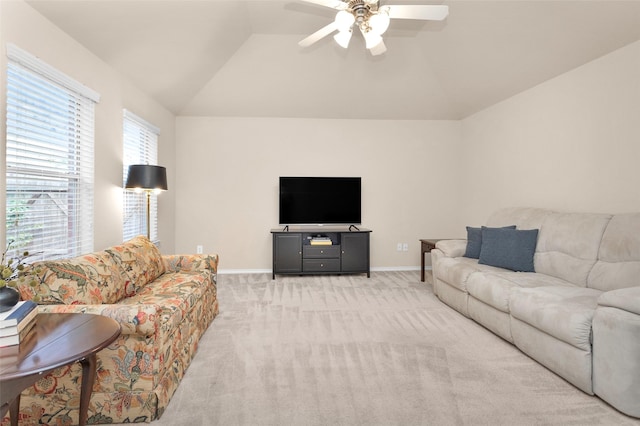 living room featuring ceiling fan, light carpet, and vaulted ceiling