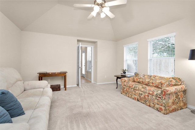 living room featuring light colored carpet, vaulted ceiling, and ceiling fan