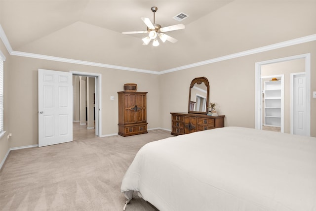 carpeted bedroom with vaulted ceiling, ceiling fan, a spacious closet, ornamental molding, and a closet