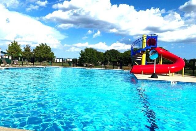 view of pool with a water slide