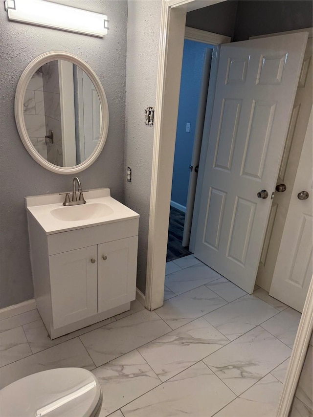 bathroom with vanity and toilet