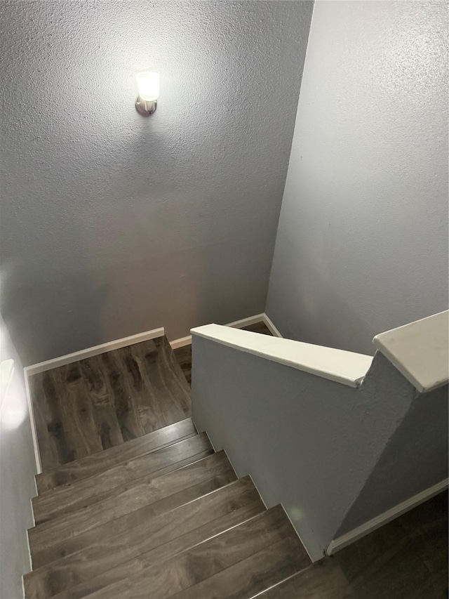 stairway featuring wood-type flooring