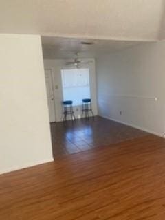 spare room with dark hardwood / wood-style flooring and ceiling fan