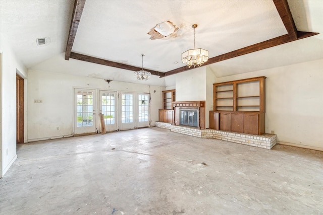 unfurnished living room with a fireplace, vaulted ceiling with beams, an inviting chandelier, and concrete floors