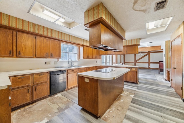 kitchen featuring sink, a kitchen island, black appliances, and a textured ceiling