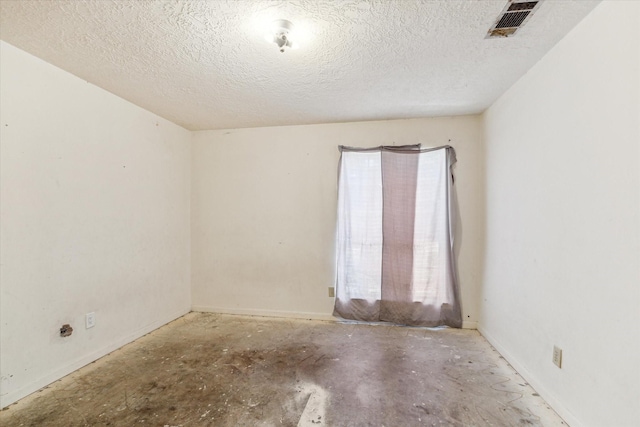 empty room featuring a textured ceiling