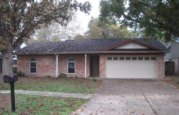 ranch-style home featuring a garage