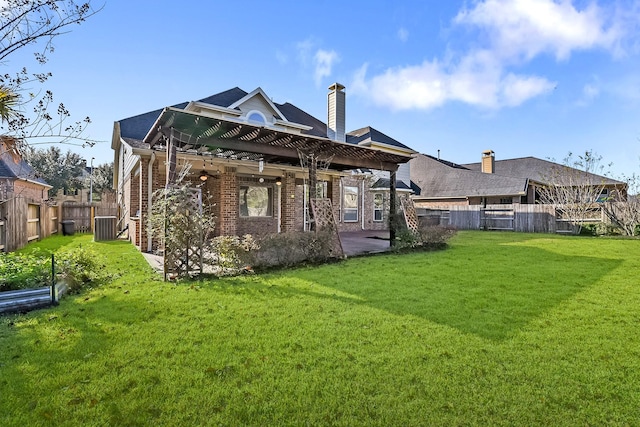 rear view of house featuring central AC unit, a pergola, and a yard