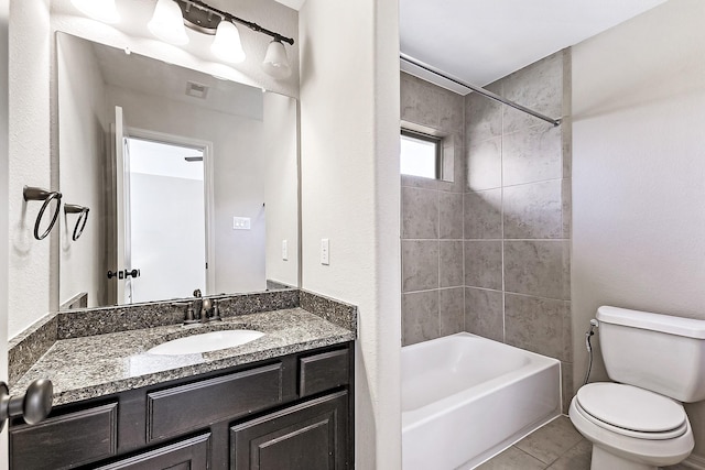 full bathroom featuring tile patterned floors, vanity, toilet, and tiled shower / bath