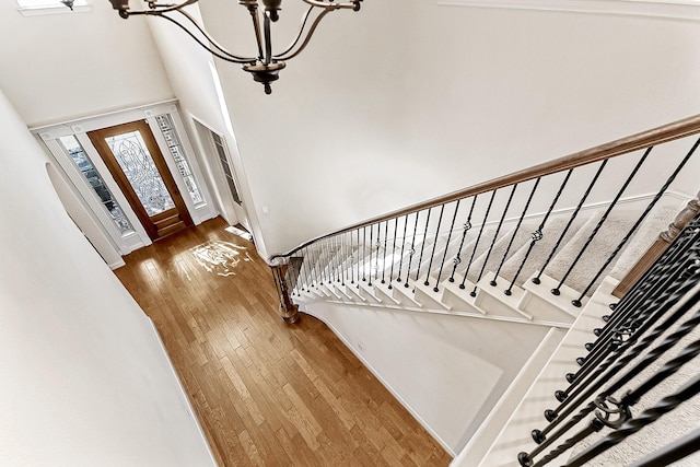 entryway featuring hardwood / wood-style flooring and a notable chandelier