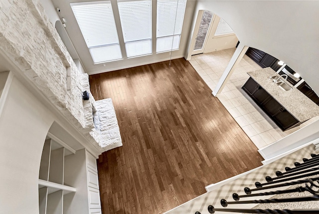 unfurnished living room with wood walls, tile patterned flooring, and sink