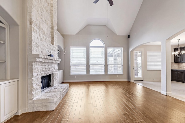 unfurnished living room featuring a fireplace, a healthy amount of sunlight, and wood-type flooring