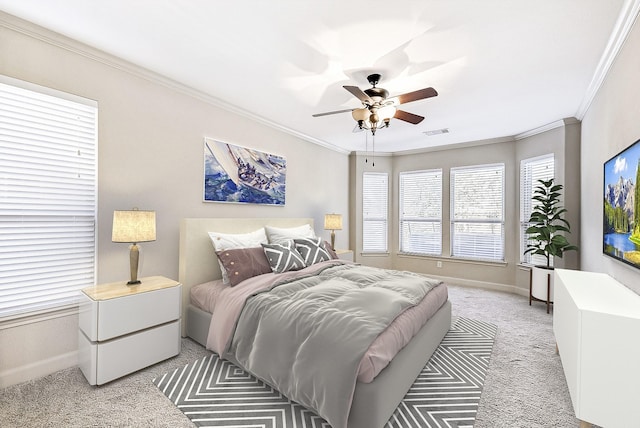 bedroom featuring ceiling fan, crown molding, and light colored carpet