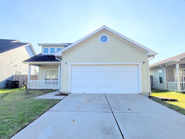 view of front of house with covered porch, a garage, and a front yard