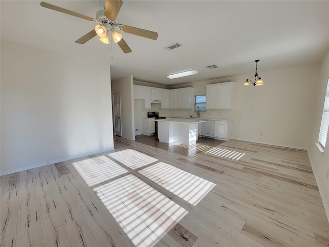 unfurnished living room with ceiling fan with notable chandelier, light hardwood / wood-style flooring, and sink